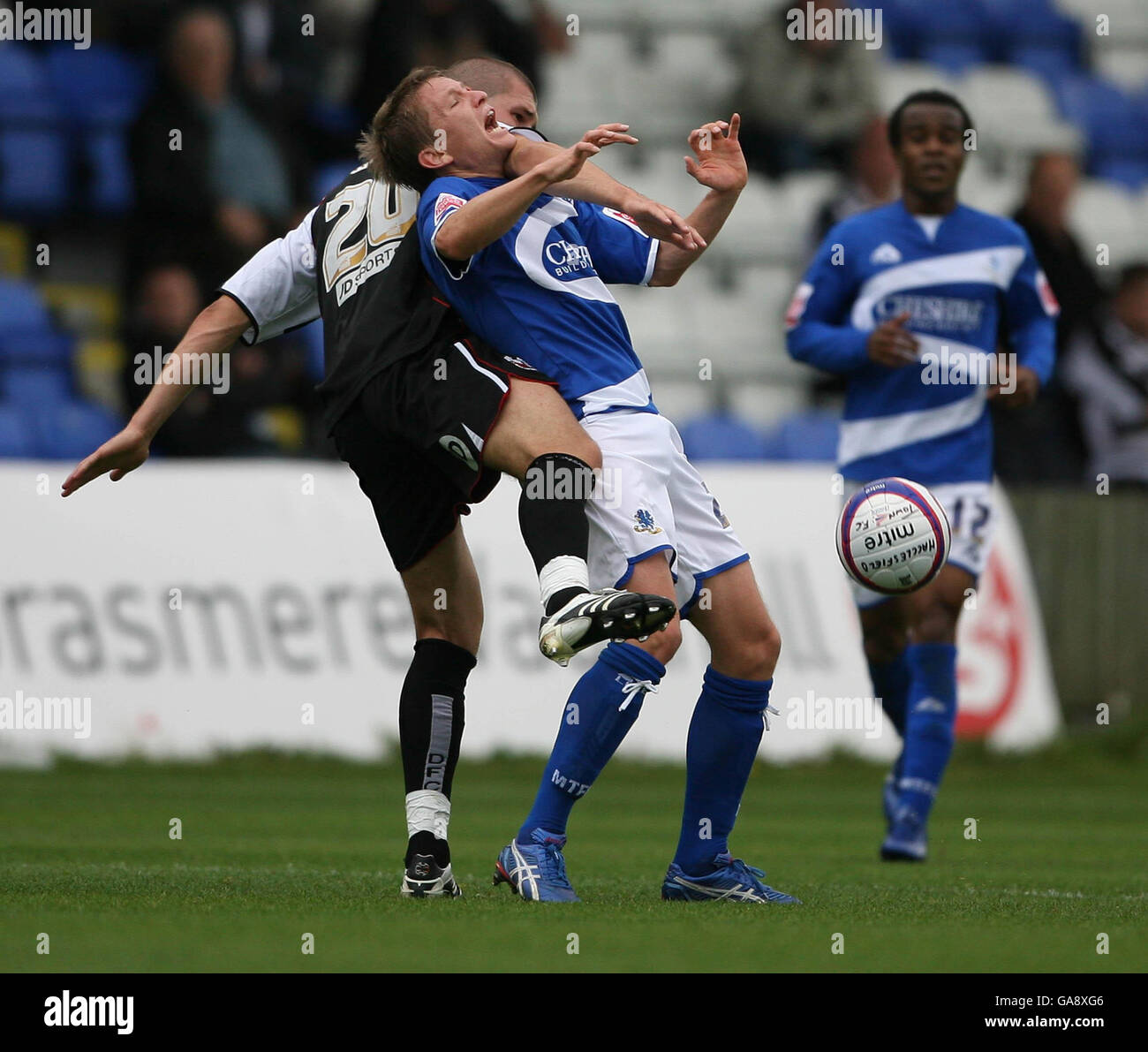 Macclesfield Town's Terry Dunfield tussles with Darlington's Tommy Wright (left) during the League Two match at Moss Rose, Macclesfield. Stock Photo