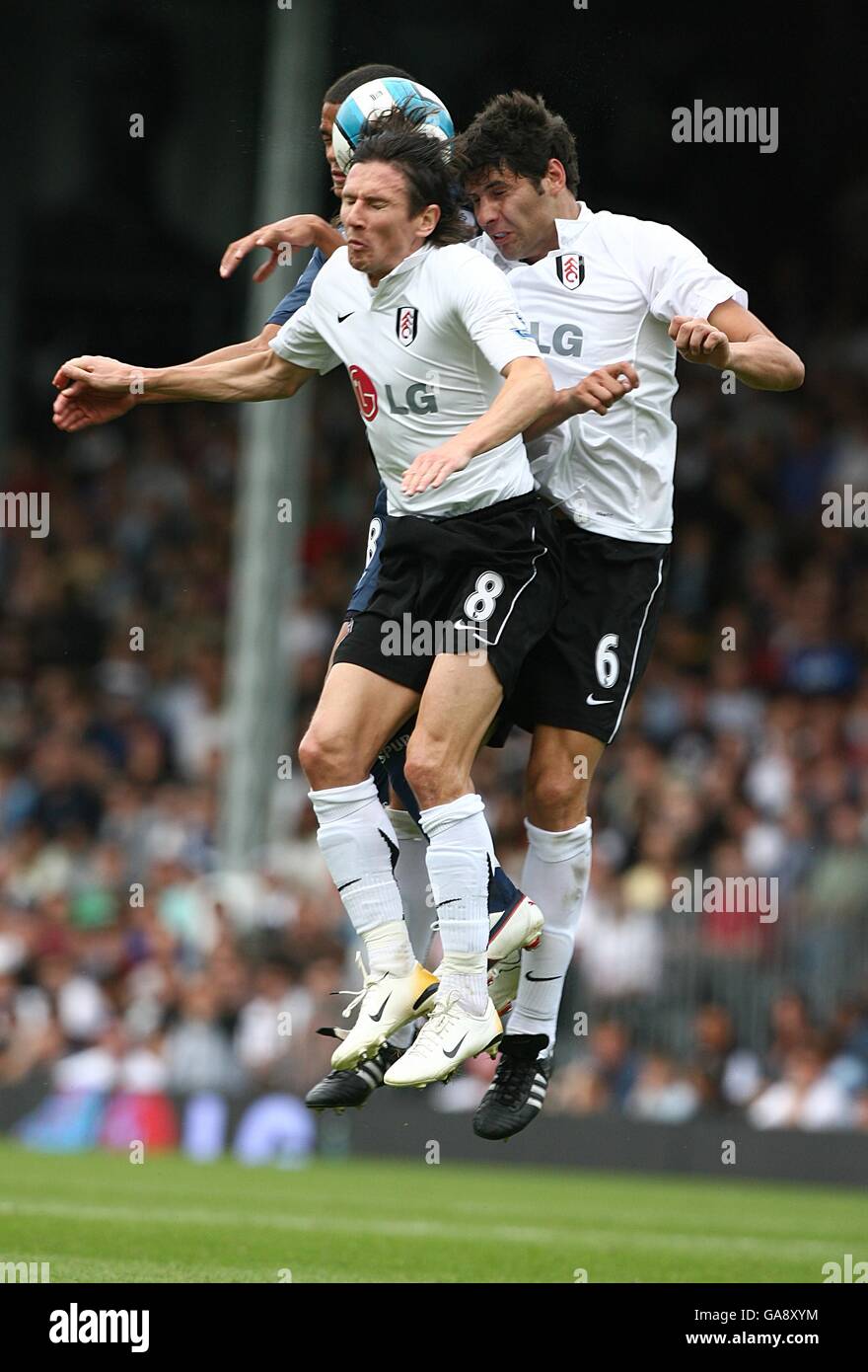 Tottenham Hotspur's Jermaine Jenas battles with Fulham's Dejan Stefanovic and Alexey Smertin for the ball Stock Photo