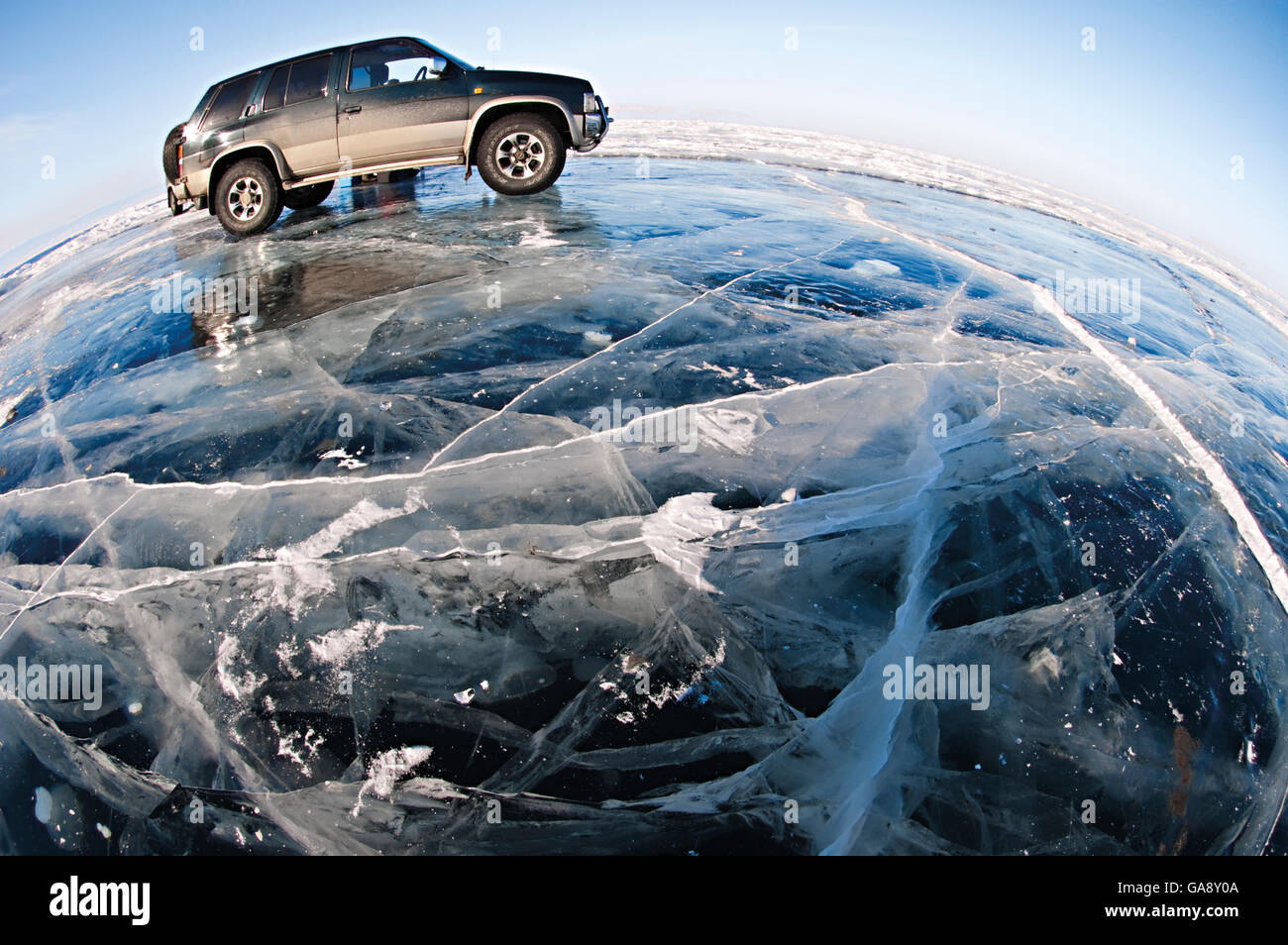 Wide angle view of vehicle parked on ice on lake surface. Lake Baikal, Siberia, Russia, March 2007. Stock Photo