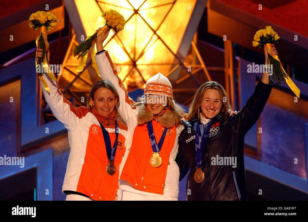 Germany's Anni Friesinger (c) celebrates winning the gold medal with Germany's silver medalist Sabine Voelker (l) and USA's bronze medalist Jennifer Rodriguez (r) Stock Photo