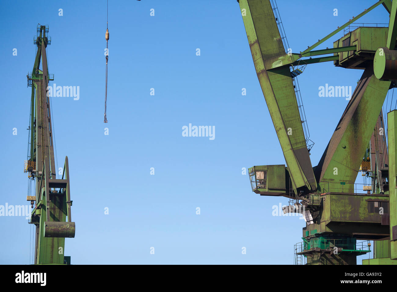 Giant green cranes stand over the Gdansk Shipyard, the birthplace of the Soidarity trade union and revolution in Gdansk, Poland Stock Photo