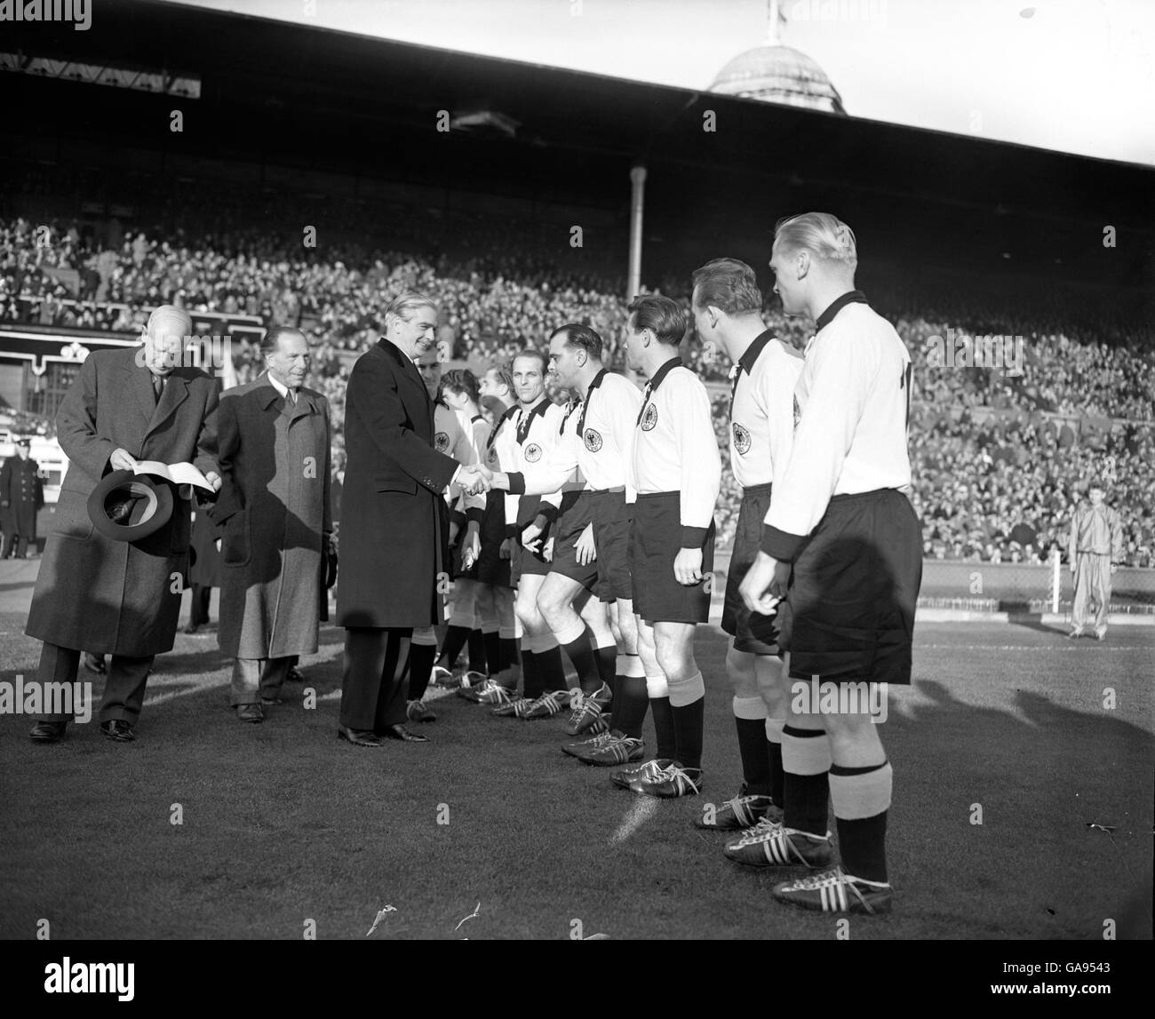 Sir Anthony Eden, British Foreign Minister shakes hands with members of the German team before the match at Wembley. Stock Photo