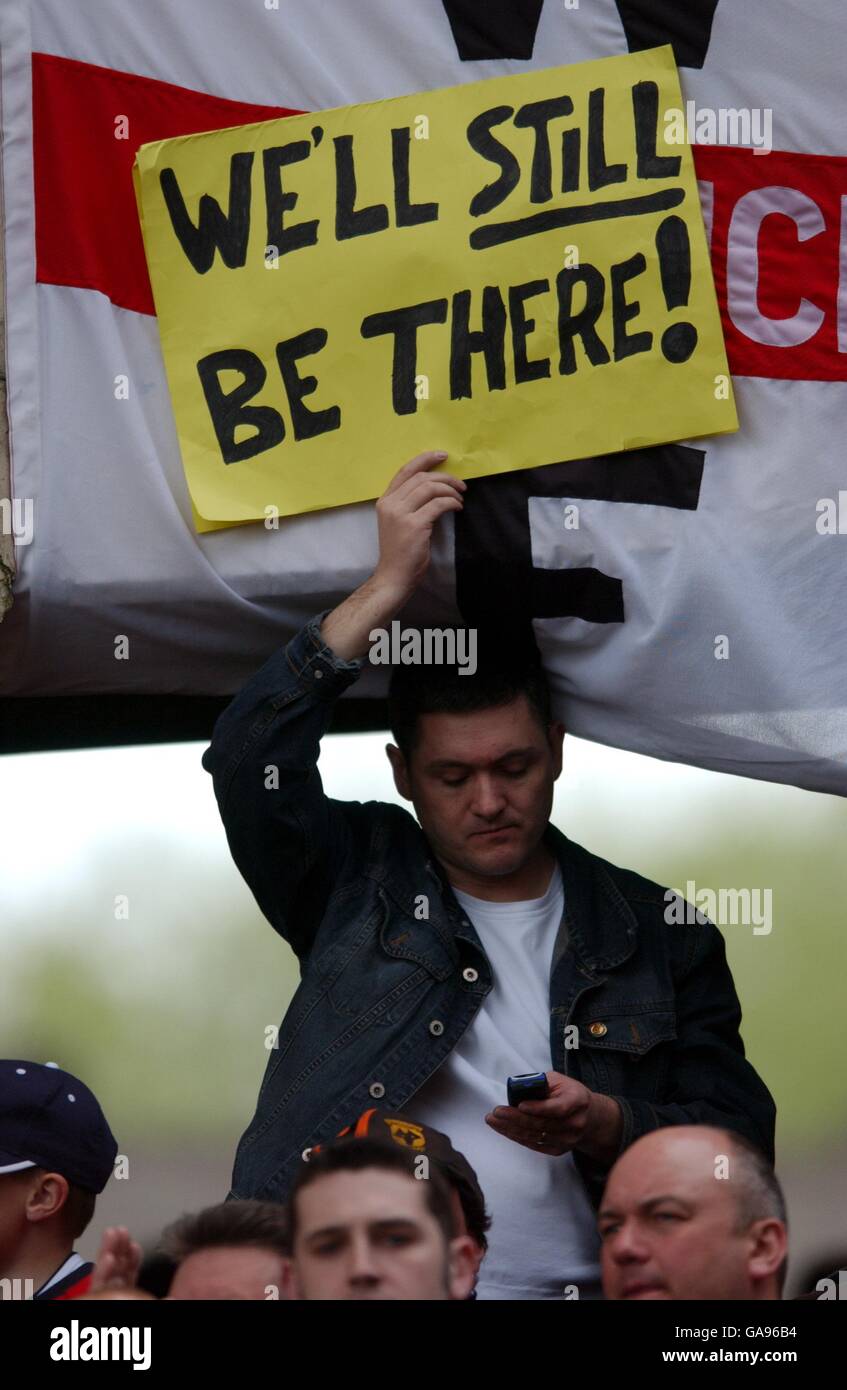 A Wolverhampton Wanderers' fan holds up a message to announce