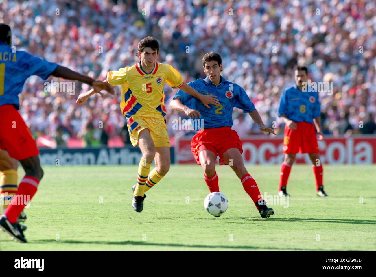 Soccer - World Cup USA 94 - Group A - Colombia v Romania. Colombia's Andres Escobar (r) plays the ball through before Romania's Ioan Lupescu (l) can tackle him Stock Photo