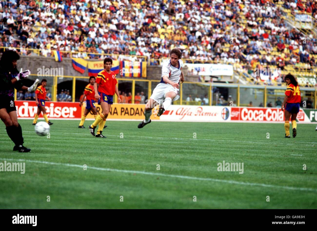Yugoslavia's Dragan Stojkovic (c) lashes the ball at goal after play stopped, watched by Colombia's Andres Escobar (no2) Stock Photo
