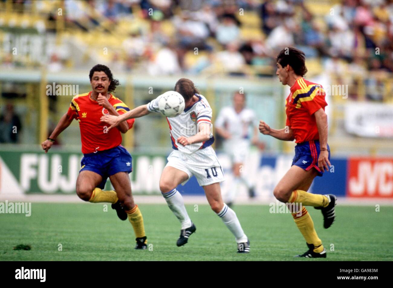 Yugoslavia's Dragan Stojkovic (c) bursts between Colombia's Andres Escobar (r) and Gildardo Gomez (l) Stock Photo