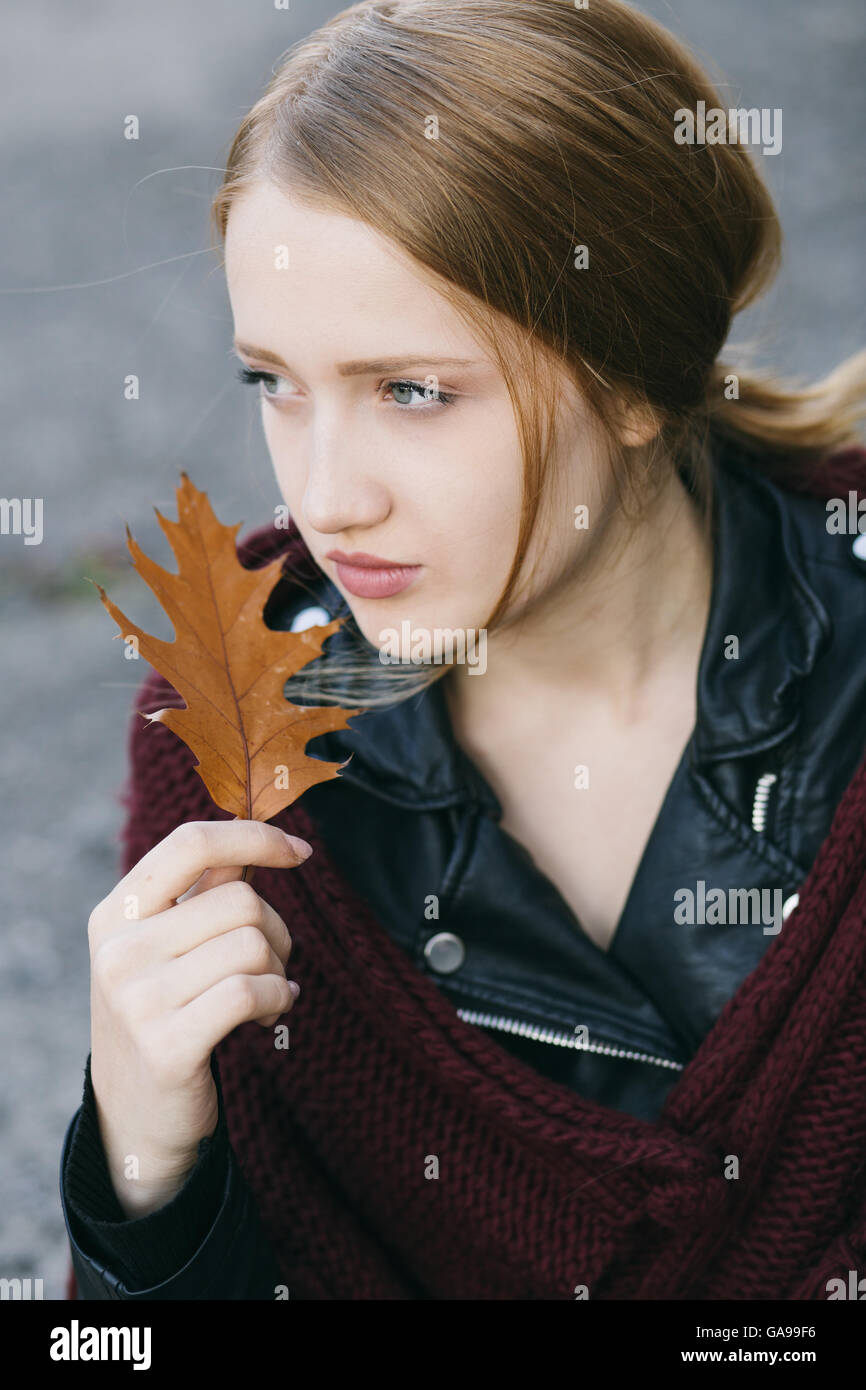 Beautiful girl holding autumn leaf Stock Photo