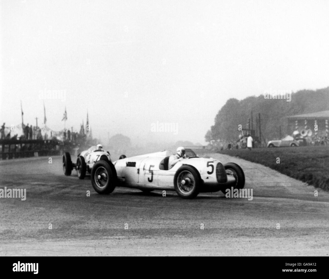 Motor Racing - Grand Prix - Donington. Auto Union's Bernd Rosemeyer (5) leads teammate Herman-Paul Muller (7) around Red Gate Corner Stock Photo