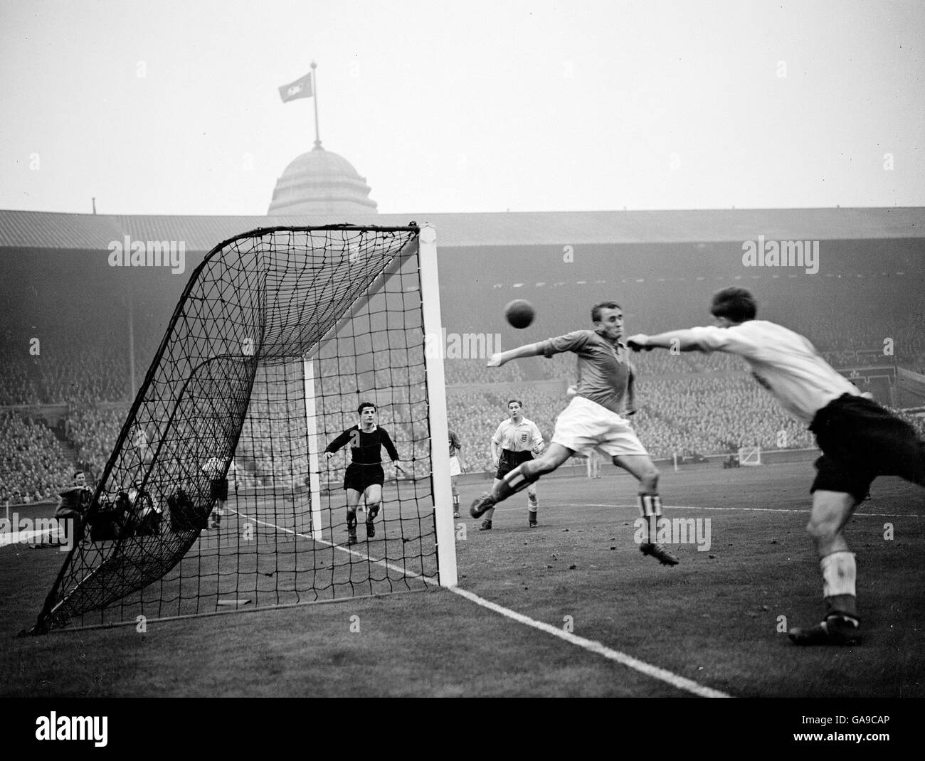 England's Jimmy Mullen (right) has an unsuccessful attempt at goal