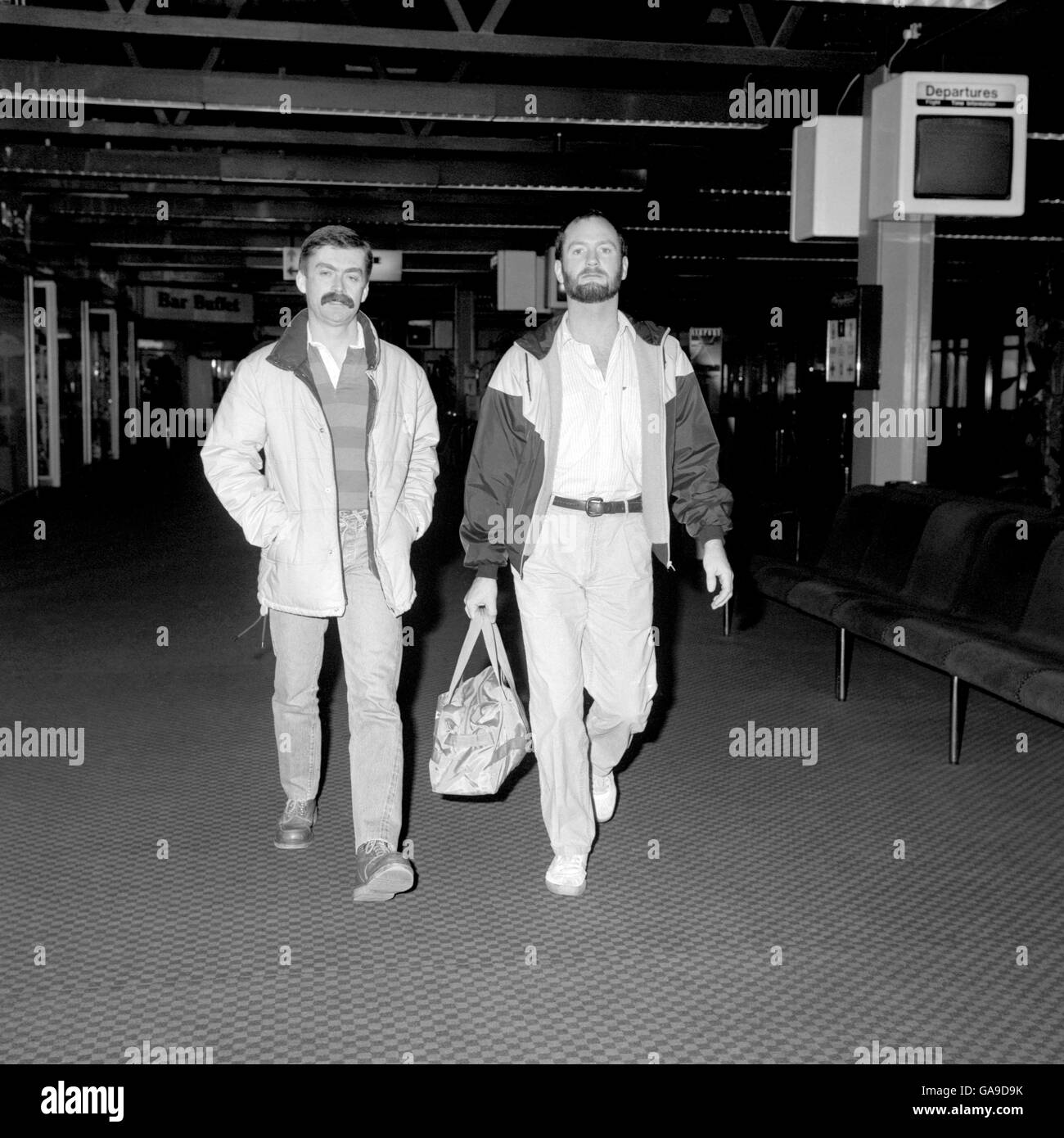 Comedian Kenny Everett (right) at London's Heathrow Airport accompanied by a friend named only as Brian, when he left for a holiday in Madrid. Stock Photo
