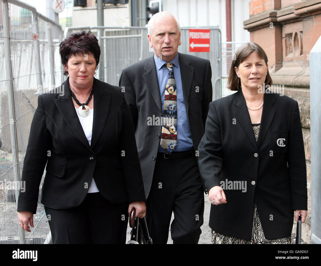 Sam Torney (centre), the brother of Police Constable John Torney, leaves Belfast Coroners court with his wife Hilary (right) and sister Elizabeth Ferguson (left) following the inquest into John's death in prison. Stock Photo