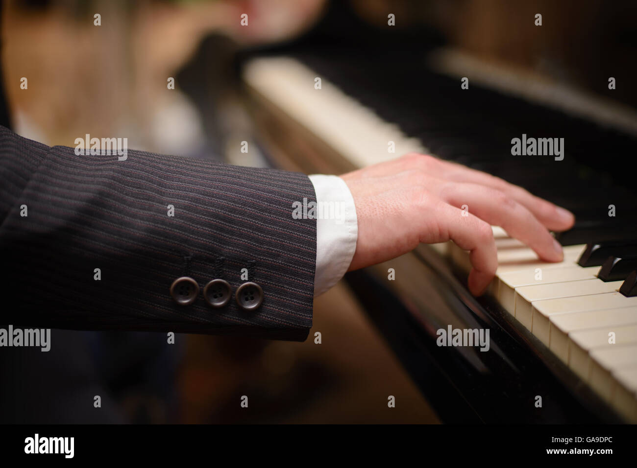 Close-up of a music performer's hand playing the piano Stock Photo