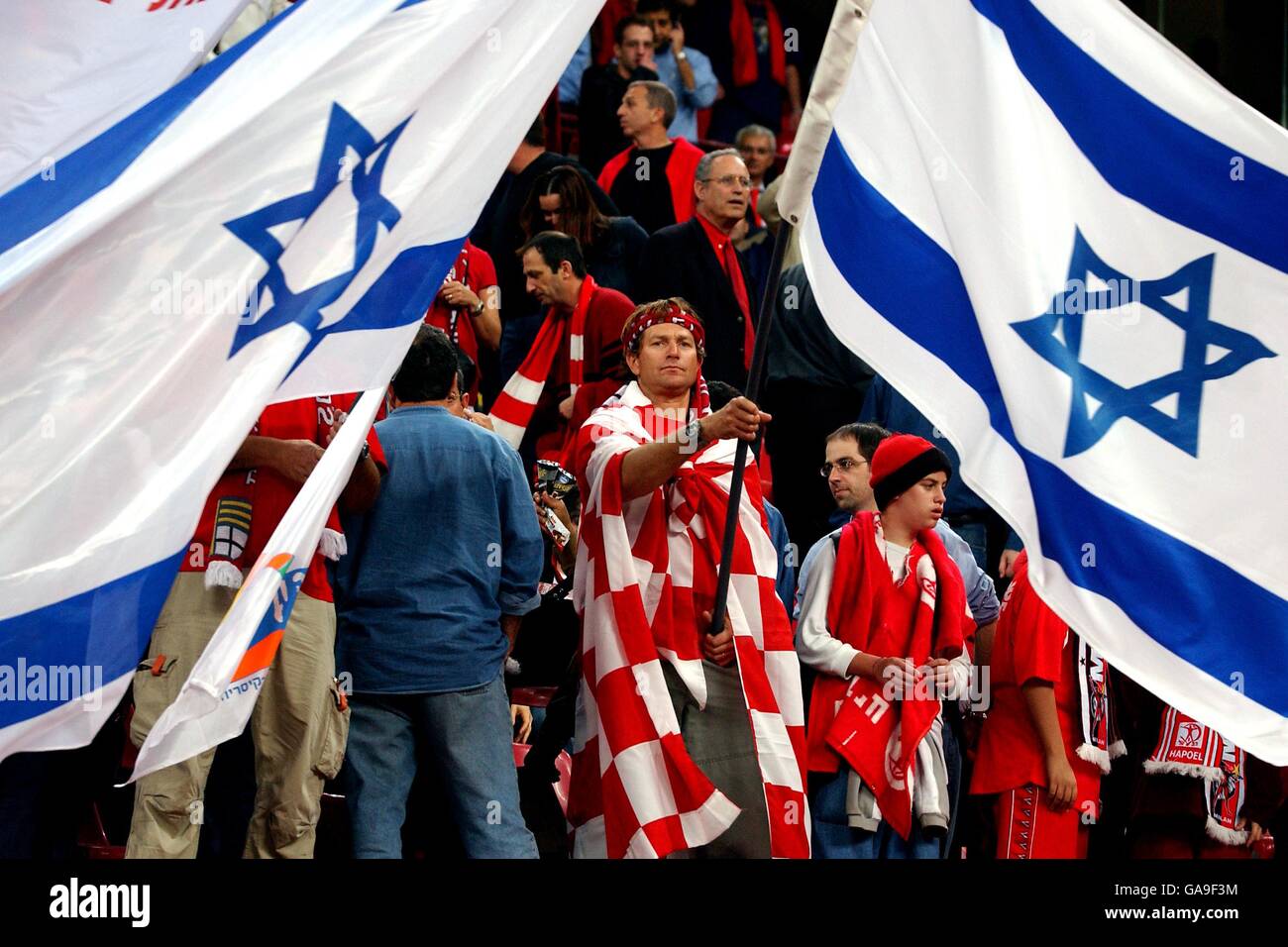 Soccer - UEFA Cup - Quarter Final - AC Milan v Hapoel Tel Aviv. A Hapoel Tel Aviv fan with a huge Israel flag Stock Photo