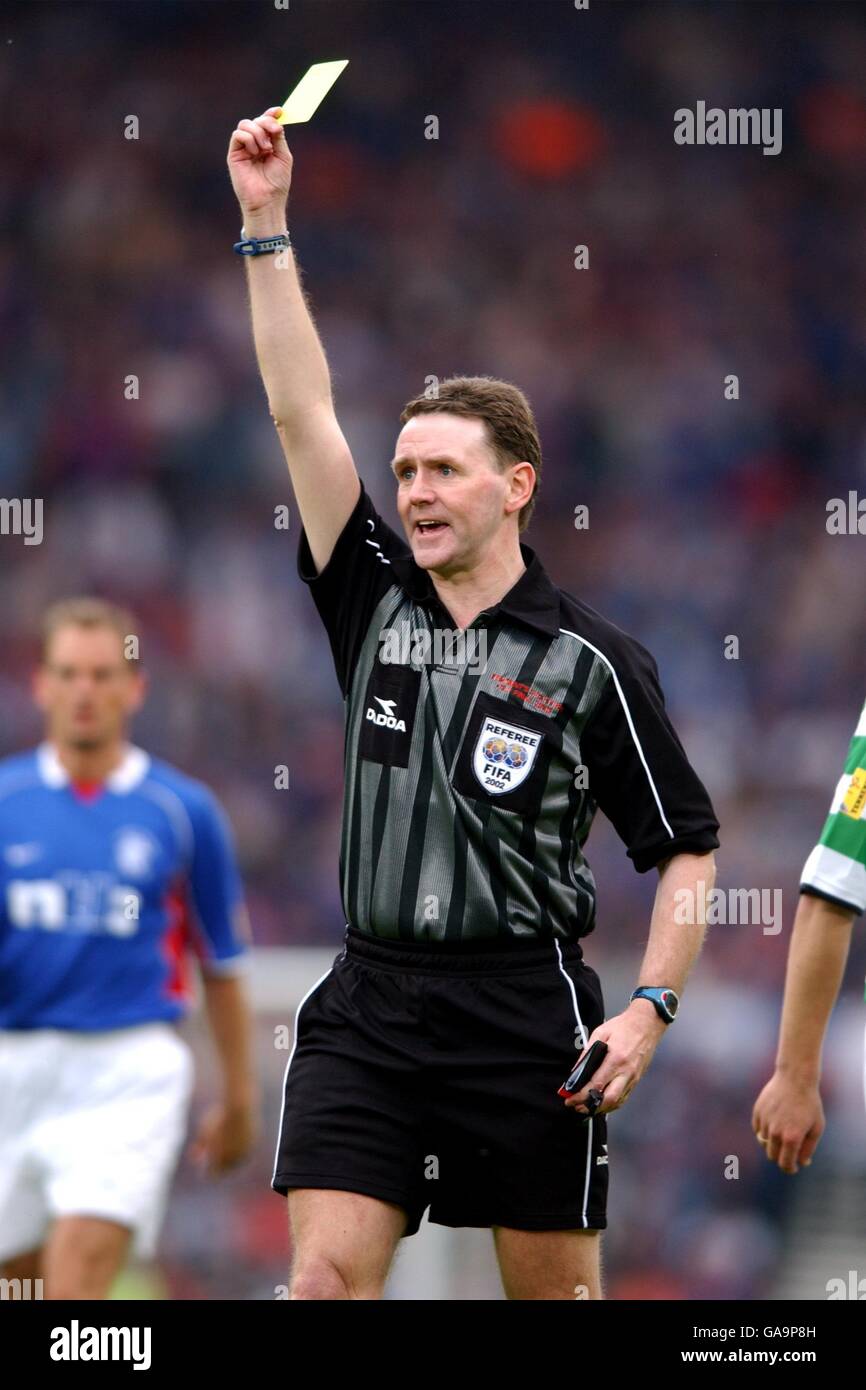 Soccer - Tennent's Scottish Cup Final - Celtic v Rangers. Referee Hugh Dallas shows a yellow card Stock Photo