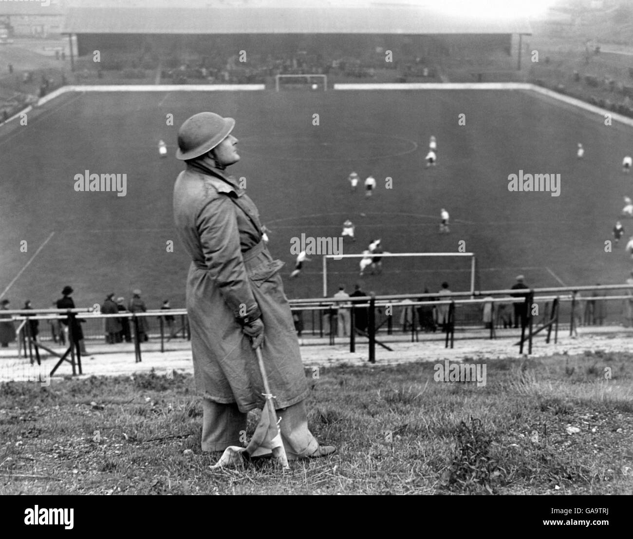 The ban on football during the periods of Alert has now been removed and play will now go on except in cases of iminent danger. Trained observers now operate and it is thought that under this scheme many more enthusiasts will be able to enjoy their favourite game. Photo shows Mr R G Brown, a qualified Observer, acting as Spotter during the Charl;ton versus Arsenal match at the Charlton Athletic Ground in South London - 7th December 1940 Stock Photo