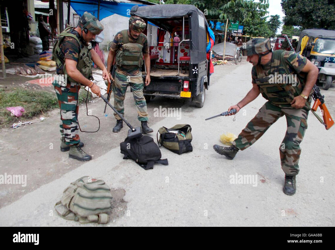 (160805) -- KOKRAJHAR (INDIA), Aug. 5, 2016 (Xinhua) -- Security forces scrutinize items and bags recovered from an auto rickshaw with metal detectors near the site of an attack at Tiniali market in Kokrajhar town, northern Indian state of Assam, on Aug. 5, 2016. At least 14 people were killed and more than 20 others injured after militants opened fire and hurled grenades at a busy market in the northern Indian state of Assam, a top police official said on Friday. (Xinhua/Stringer) Stock Photo