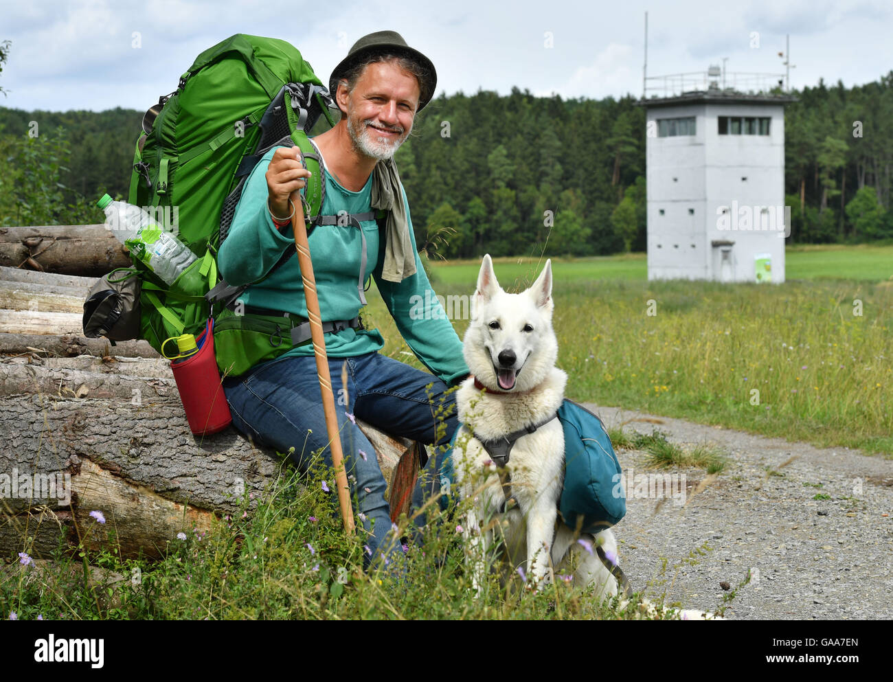 Adventurer Mario Goldstein hiking along the 'Green Band' (Gruenes Band), the former death zone along the border of the GDR and the current state border between Thuringia and Bavaria near Behrungen, Germany, 5 August 2016. Since the middle of July, Goldstein is hiking the 764 kilometer long hiking track. Mario Goldstein and the association BUND campaign for the Green Band, which is said to become a national nature monument. PHOTO: MARTIN SCHUTT/dpa Stock Photo