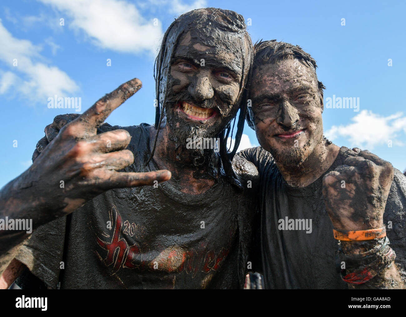 Wacken, Germany. 5th Aug, 2016. Metal fans celebrating on the festival grounds of Wacken Open Air in Wacken, Germany, 5 August 2016. 75,000 fans are attending what organisers say is the largest heavy metal festival in the world. PHOTO: AXEL HEIMKEN/dpa/Alamy Live News Stock Photo