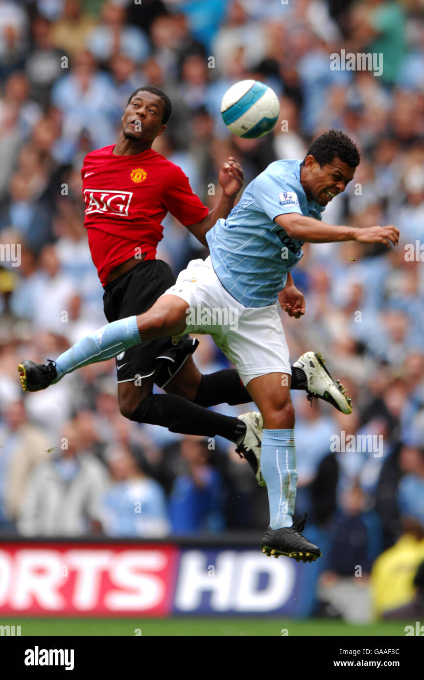 Soccer - Barclays Premier League - Manchester City v Manchester United - City Of Manchester Stadium. Manchester City's Geovanni (r) and Manchester United's Patrice Evra battle for the ball in the air Stock Photo