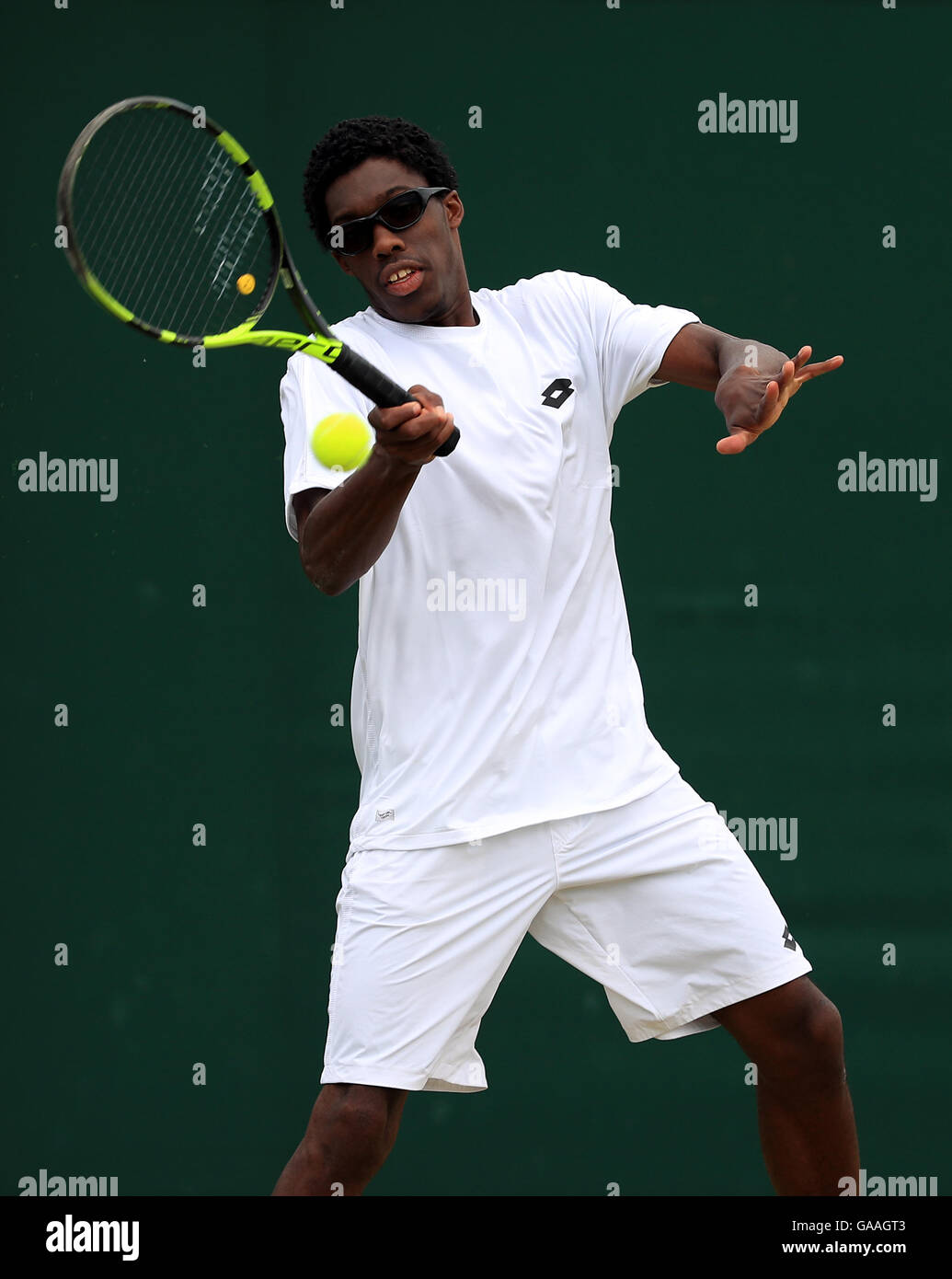 Olukayode Alafia Damina Ayeni in action in the boys singles on day seven of the Wimbledon Championships at the All England Lawn Tennis and Croquet Club, Wimbledon. PRESS ASSOCIATION Photo. Picture date: Monday July 4, 2016. See PA story TENNIS Wimbledon. Photo credit should read: Adam Davy/PA Wire. RESTRICTIONS: Editorial use only. No commercial use without prior written consent of the AELTC. Still image use only - no moving images to emulate broadcast. No superimposing or removal of sponsor/ad logos. Call +44 (0)1158 447447 for further information. Stock Photo