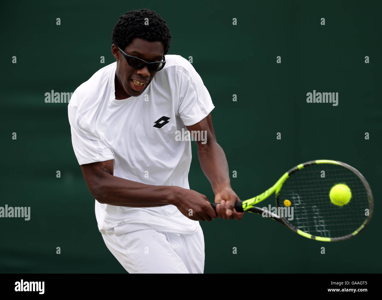 Olukayode Alafia Damina Ayeni in action in the boys singles on day seven of the Wimbledon Championships at the All England Lawn Tennis and Croquet Club, Wimbledon. PRESS ASSOCIATION Photo. Picture date: Monday July 4, 2016. See PA story TENNIS Wimbledon. Photo credit should read: Adam Davy/PA Wire. RESTRICTIONS: Editorial use only. No commercial use without prior written consent of the AELTC. Still image use only - no moving images to emulate broadcast. No superimposing or removal of sponsor/ad logos. Call +44 (0)1158 447447 for further information. Stock Photo