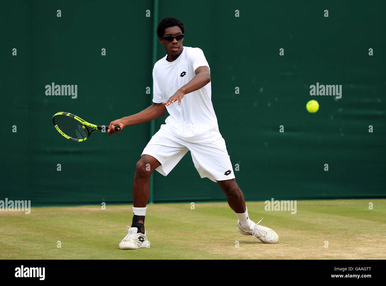 Olukayode Alafia Damina Ayeni in action in the boys singles on day seven of the Wimbledon Championships at the All England Lawn Tennis and Croquet Club, Wimbledon. Stock Photo