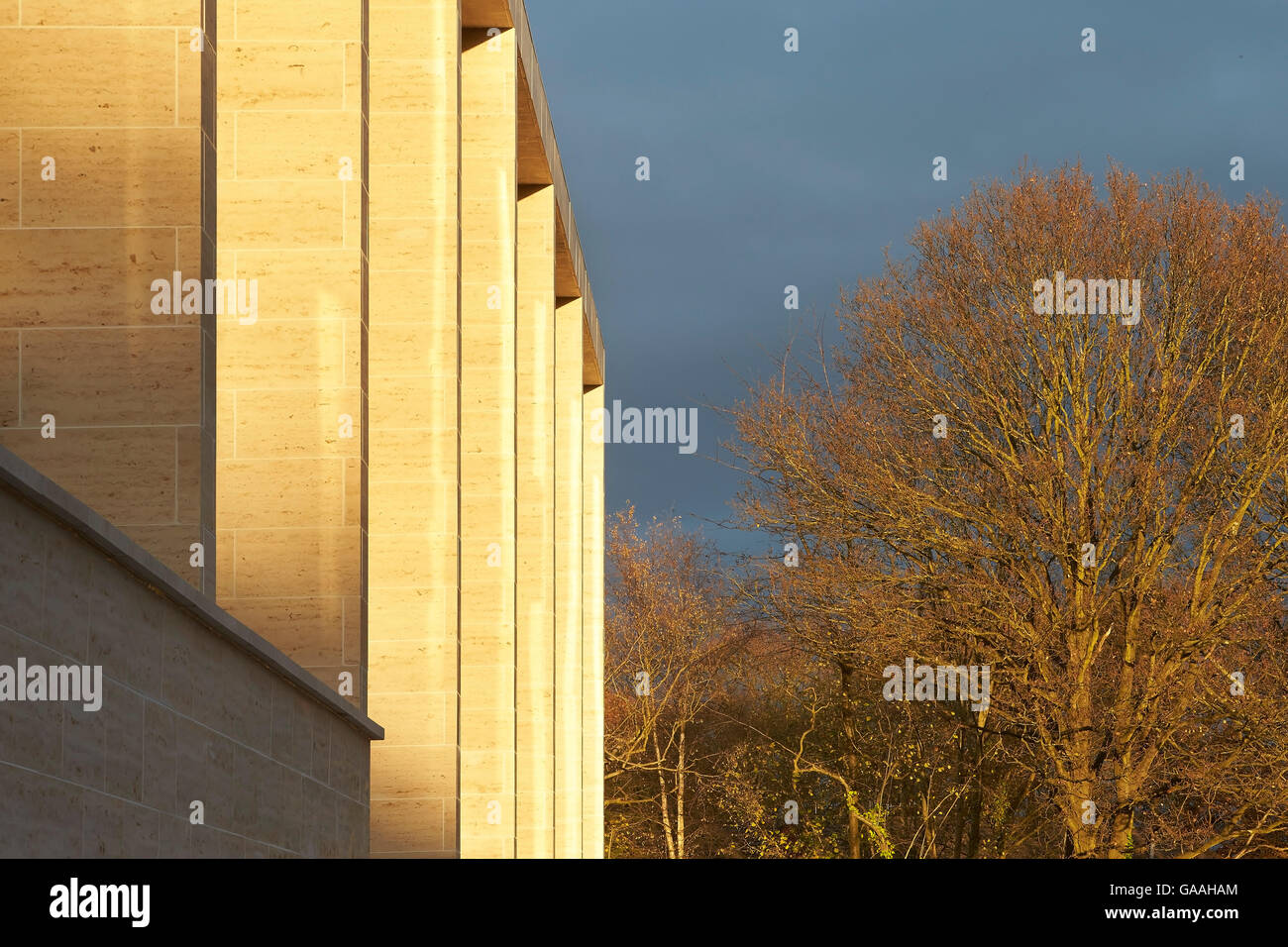 Stone clad facade in late afternoon light. Next -  Home and Garden Stores, Southampton, United Kingdom. Architect: Stanton Williams, 2014. Stock Photo