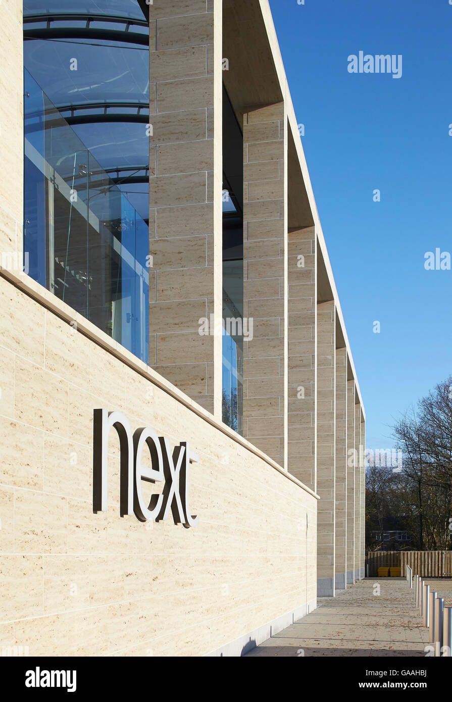 Facade and colonnade perspective with store logo. Next Home and