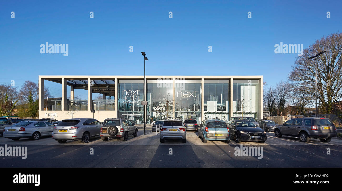 Front elevation of main entrance with full-height glazing and and car park. Next -  Home and Garden Stores, Southampton, United Stock Photo