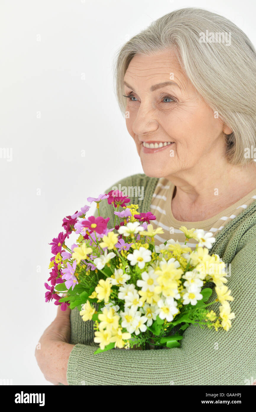 Senior woman with blooming flowers Stock Photo - Alamy