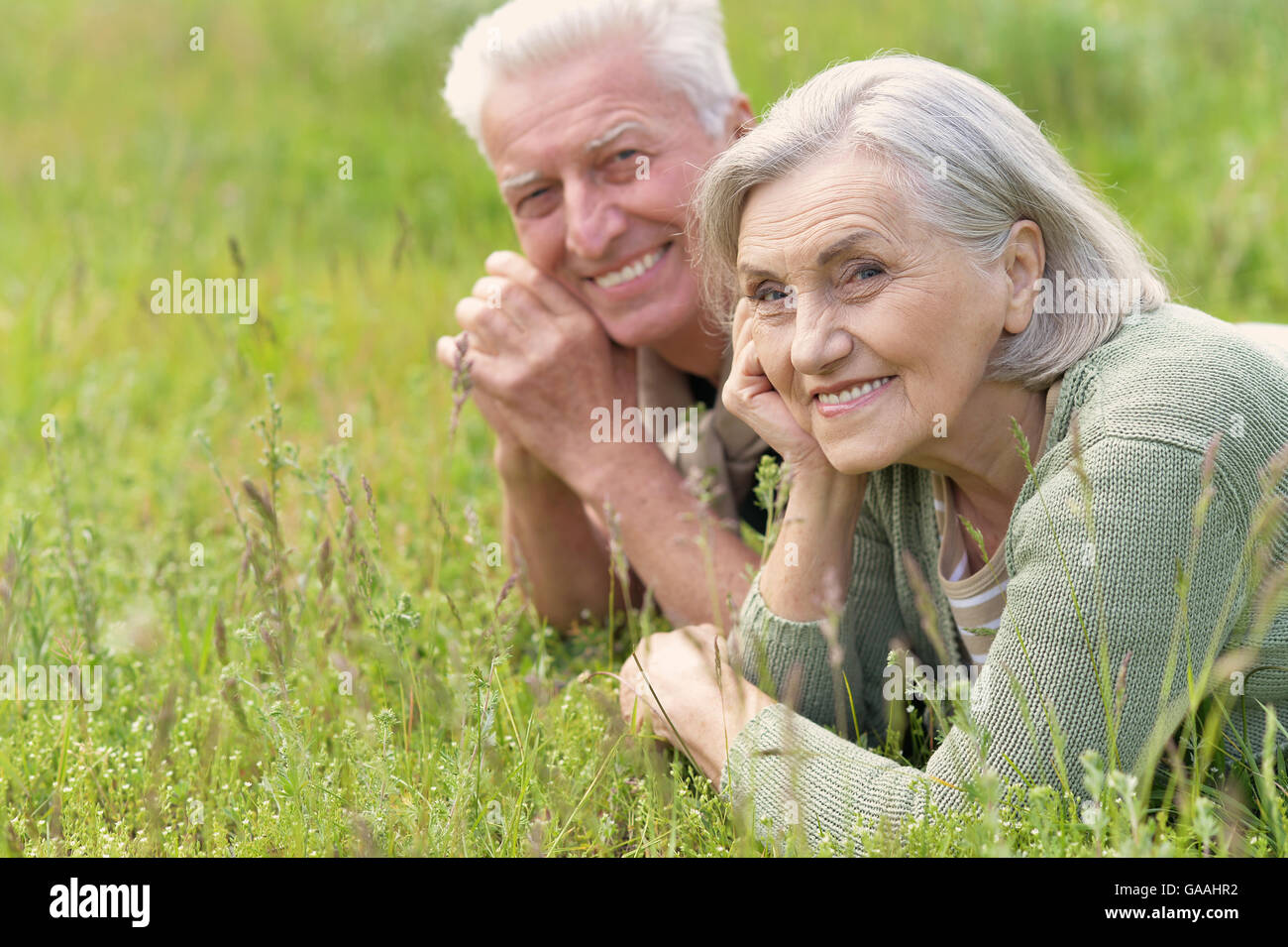 mature couple lying on grass Stock Photo - Alamy