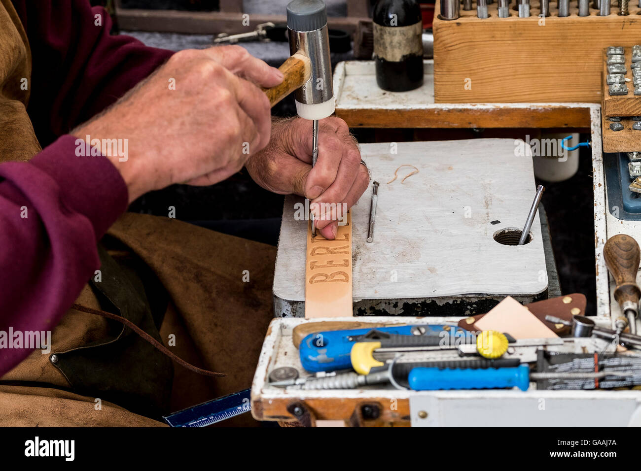 A leather worker displaying his skill at a country show Stock Photo Alamy