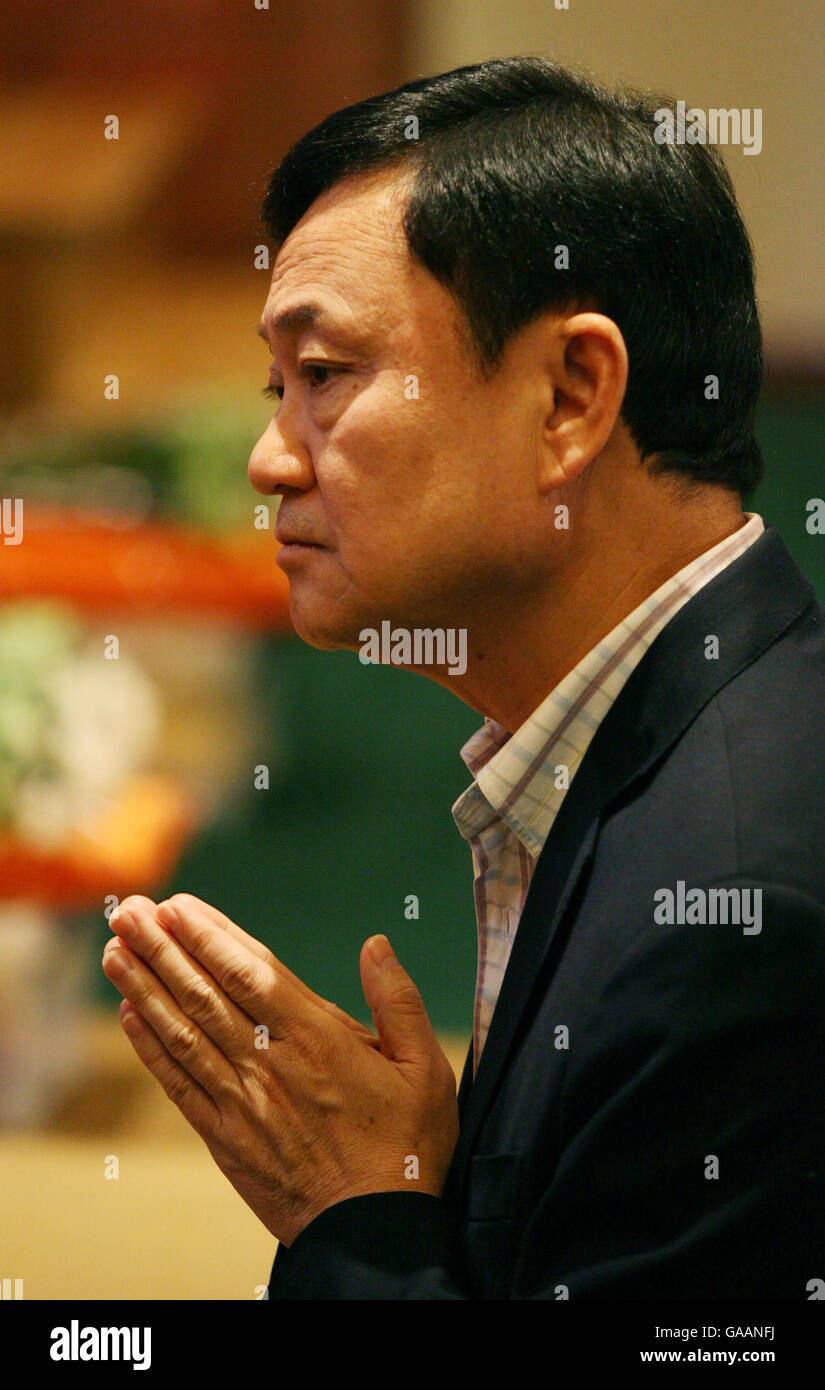 Dr. Thaksin Shinawatra, former Prime Minister of Thailand, during prayers at the Dhammakaya Centre for Buddist Meditation in Knaphill, Surrey, a year after being ousted from office. Stock Photo