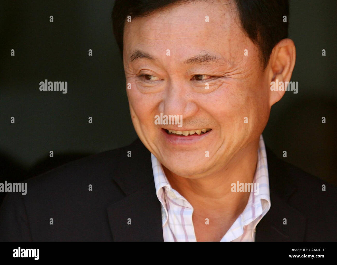 Dr. Thaksin Shinawatra, former Prime Minister of Thailand arrives at the Dhammakaya Centre for Buddhist Meditation in Knaphill, Surrey, a year after being ousted from office. Stock Photo