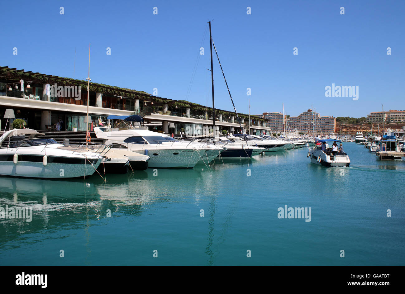 View in original section of  Port Adriano marina with Philippe Starck designed superyacht marina and commercial centre Stock Photo