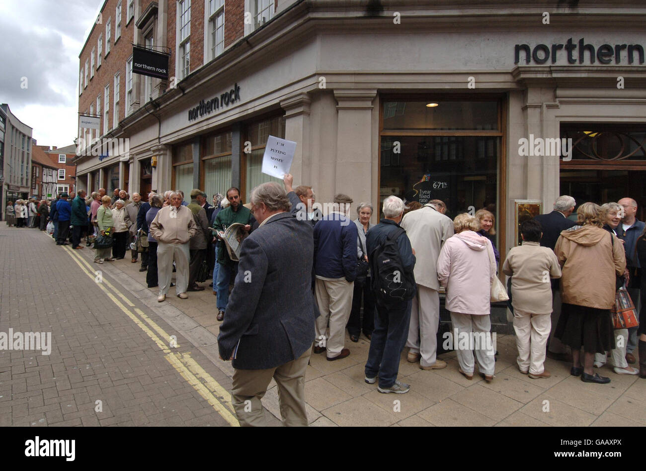 Investor in bank walks back queue make deposit hi-res stock photography ...