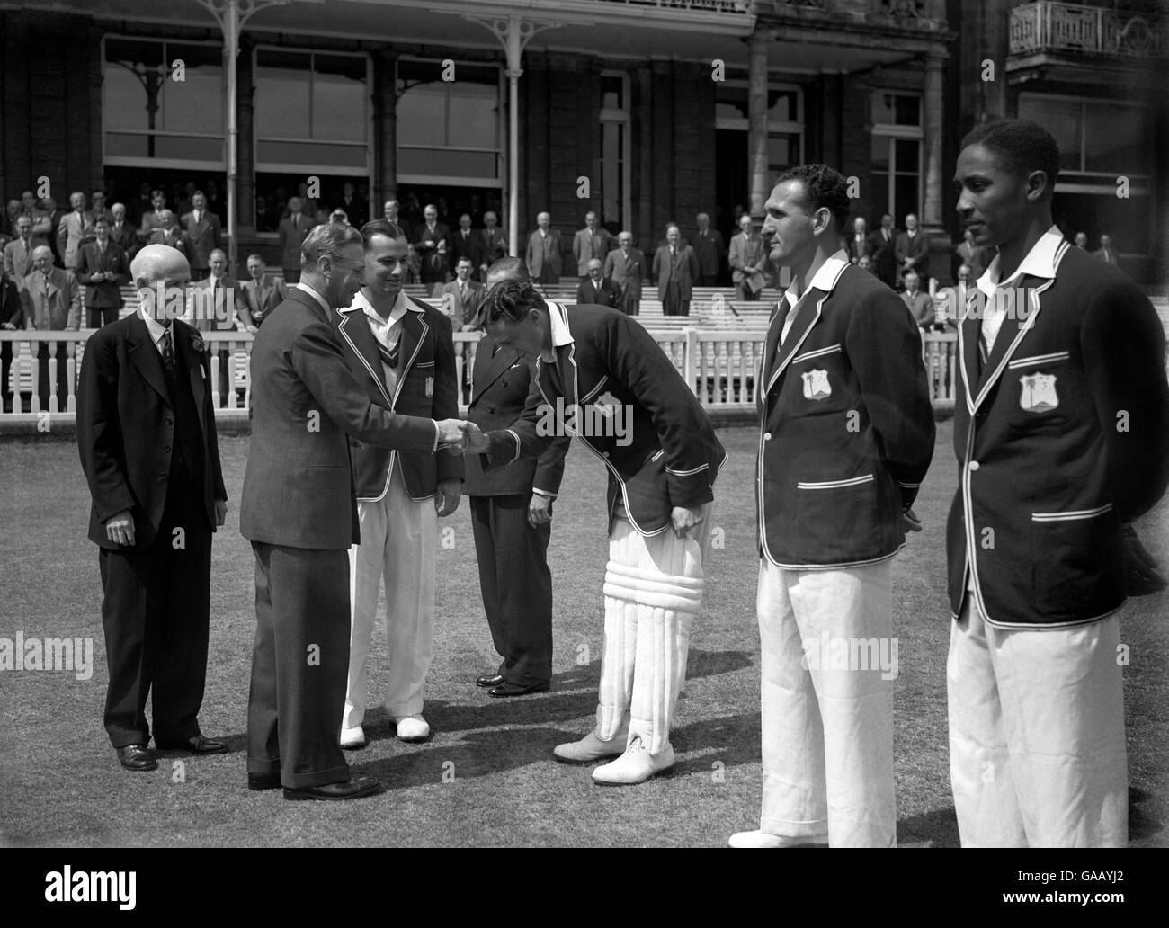 Cricket - England v West Indies - 2nd Test - Day 1 - Lord's. H.M. The King shakes hands with Jeffrey Stollmeyer of the West Indies before the match Stock Photo