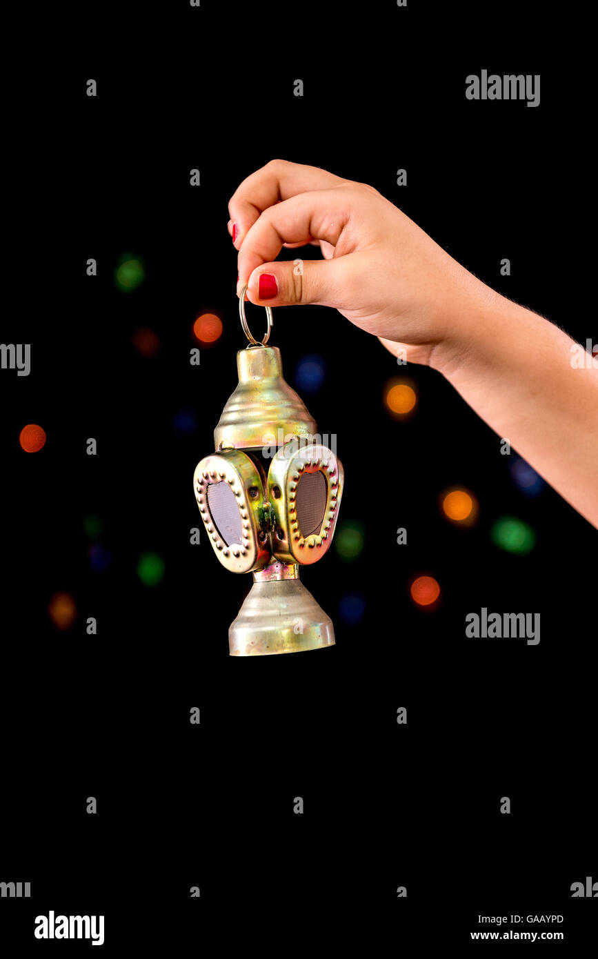 Girl Hand with Ramadan Lantern on Defocused Night Lights Background Stock Photo