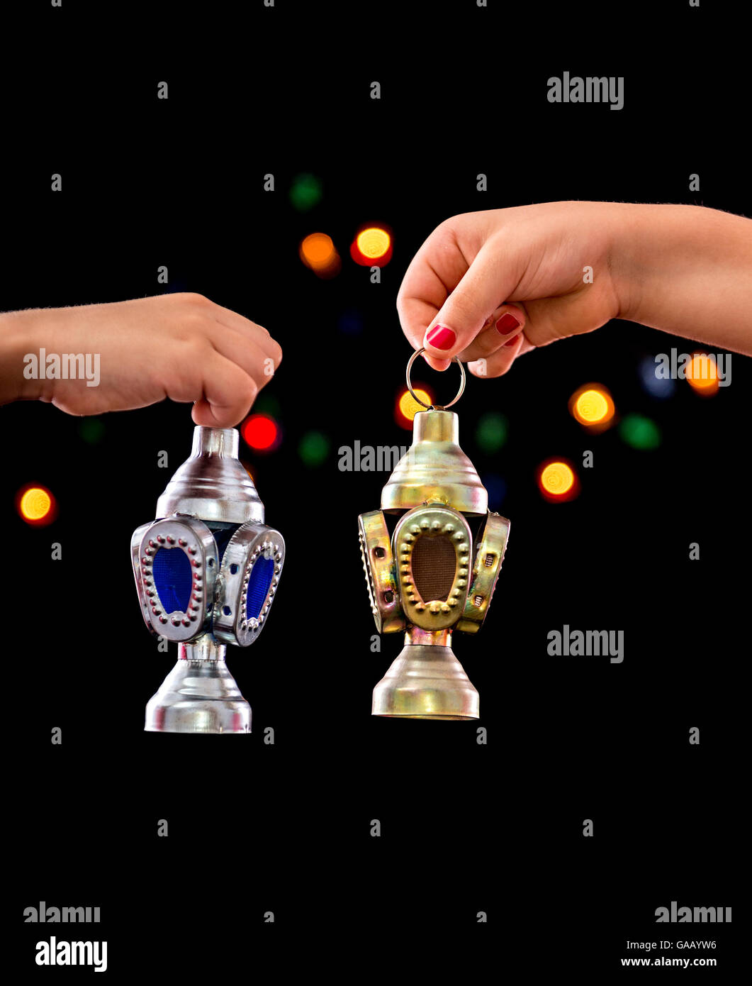 Children Hands with Ramadan Lantern on Defocused Night Lights Background Stock Photo