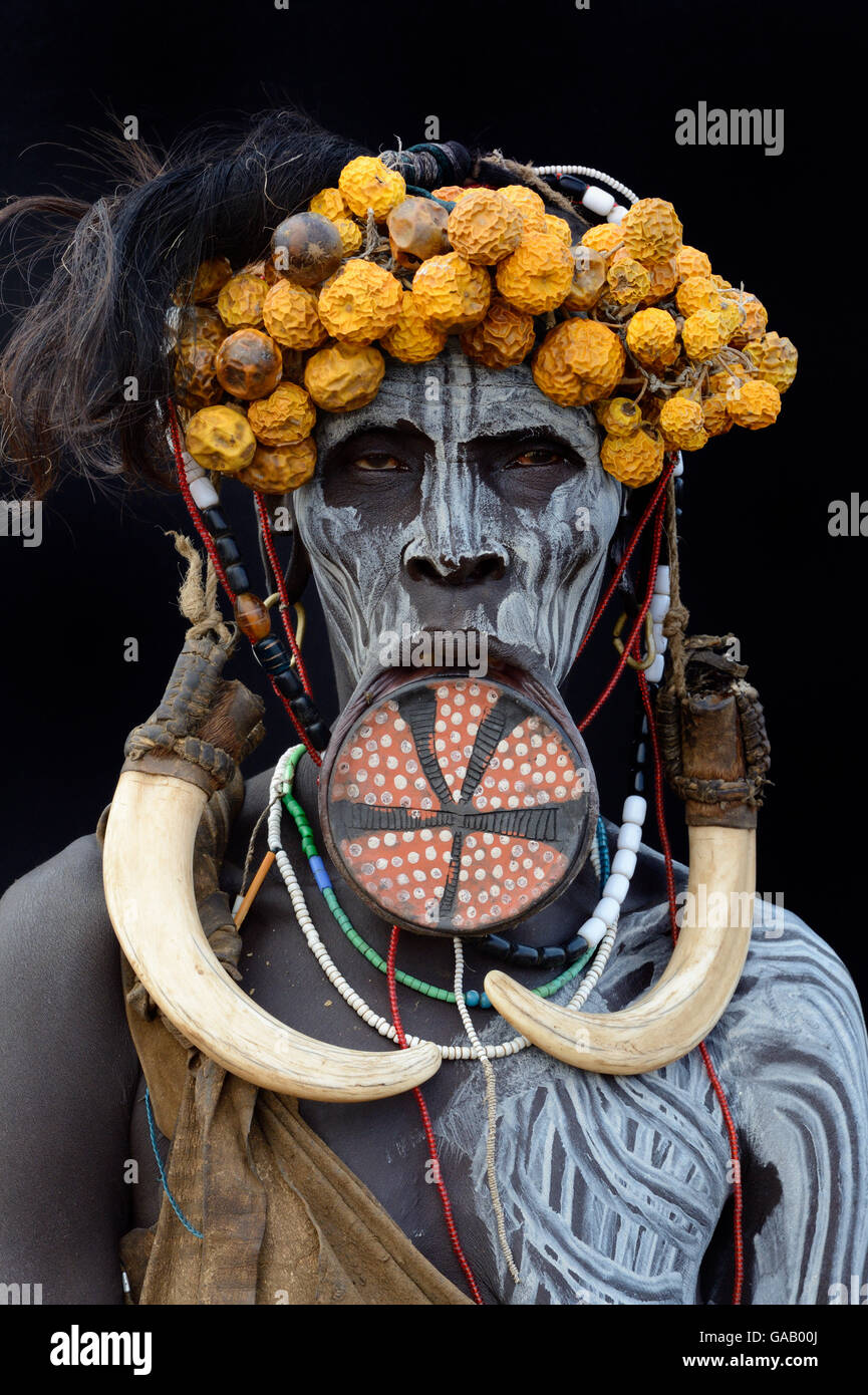 Portrait of woman from the Mursi tribe, traditionally decorated and painted, wearing a large clay lip plate, Omo Valley, Ethiopia, March 2015. Stock Photo