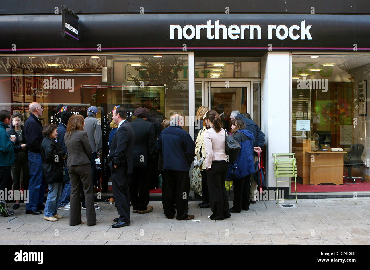 Customers queue to withdraw money from the Northern Rock Bank in Kingston-upon-Thames, Surrey. Stock Photo