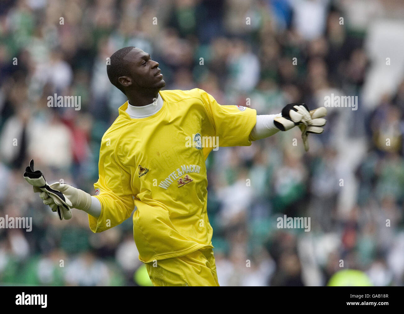 Hibernian goalkeeper Yves Ma-Kalambay throws his gloves to the fans in  celebration of beating Celtic during the Clydesdale Bank Scottish Premier  League match at Easter Road, Edinburgh Stock Photo - Alamy