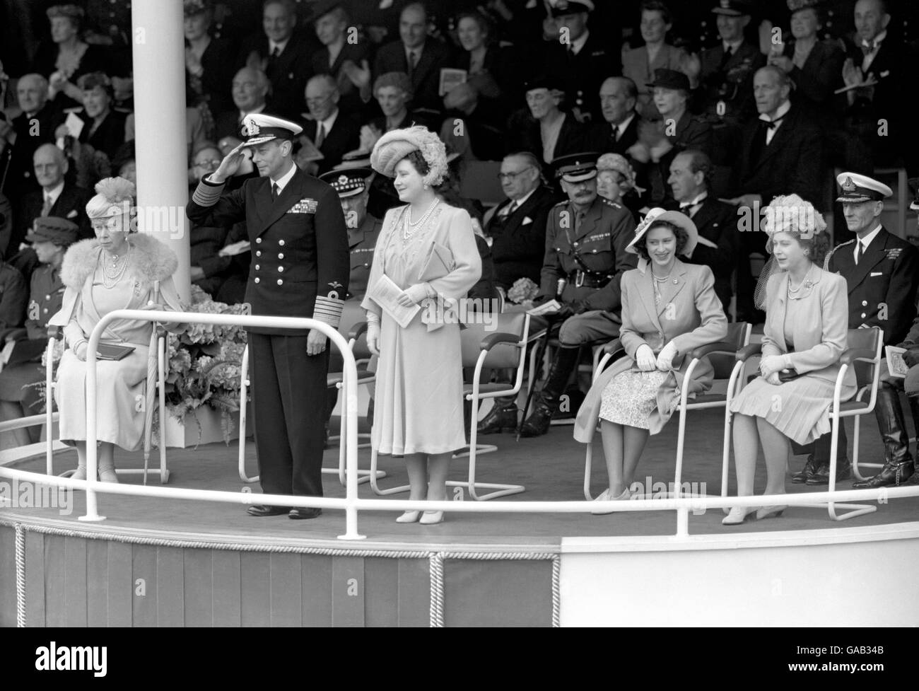 King George VI saluting the fly past of 300 RAF aircraft which took place over the Saluting Base in the Mall at the end of the Victory Parade. Stock Photo