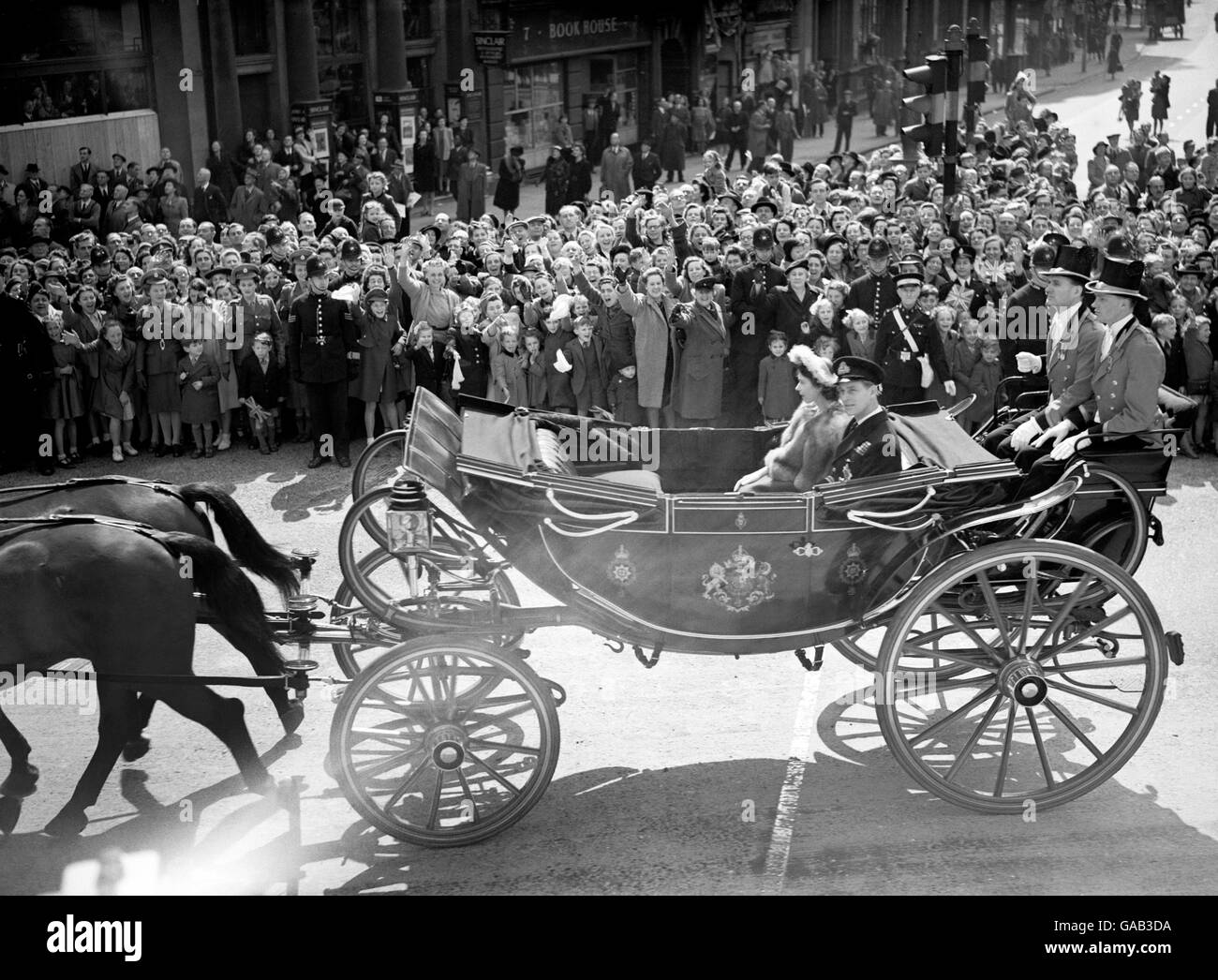 Princess Elizabeth and the Duke of Edinburgh passing through Trafalgar Square, on their way to St Paul's Cathedral for the Silver Wedding Thanksgiving Service for King George VI and Queen Elizabeth. Stock Photo