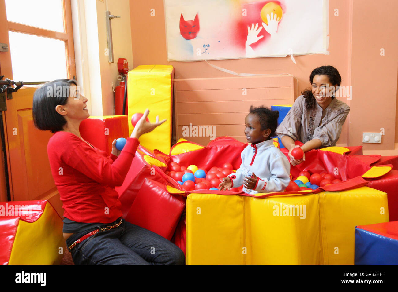 Designer Sadie Frost (left) and Capital 95.8 DJ Margherita Taylor entertain Hana, 1, during a visit to homeless project Caris Haringey in North London, funded by Capital 95.8's Help a London Child help fund. Stock Photo