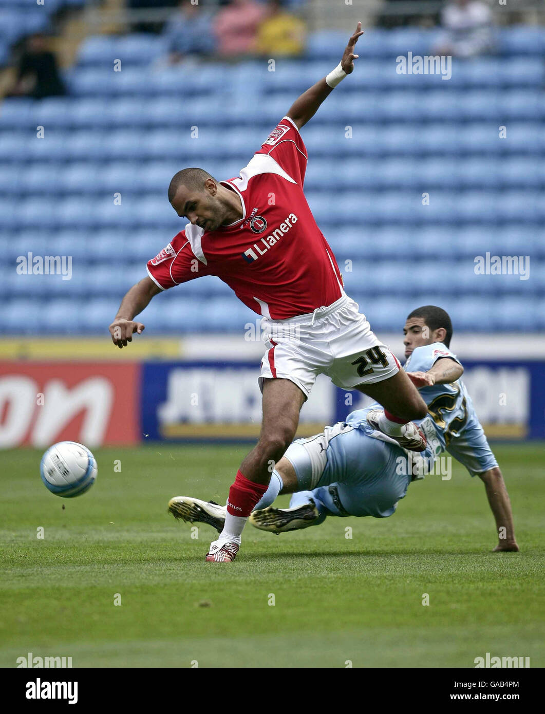 Charlton's Jon Fortune is tackled by Coventry's Leon Best (right) during the Coca-Cola Football League Championship match at the Ricoh Arena, Coventry. Stock Photo