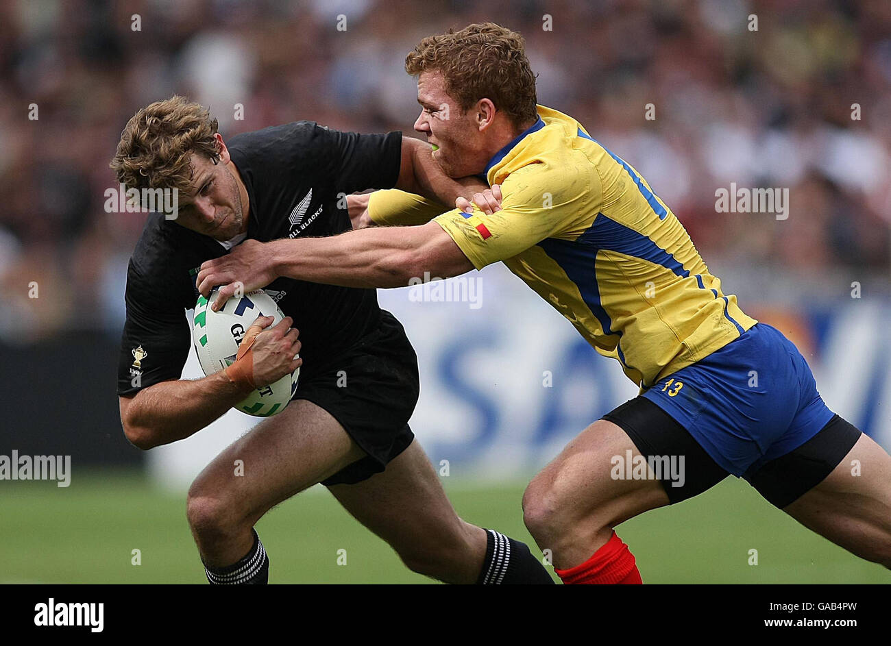 New Zealand's Nick Evans is tackled by Romania's Csaba Gal during the IRB Rugby World Cup Pool C match at Le Stade, Toulouse, France. Stock Photo