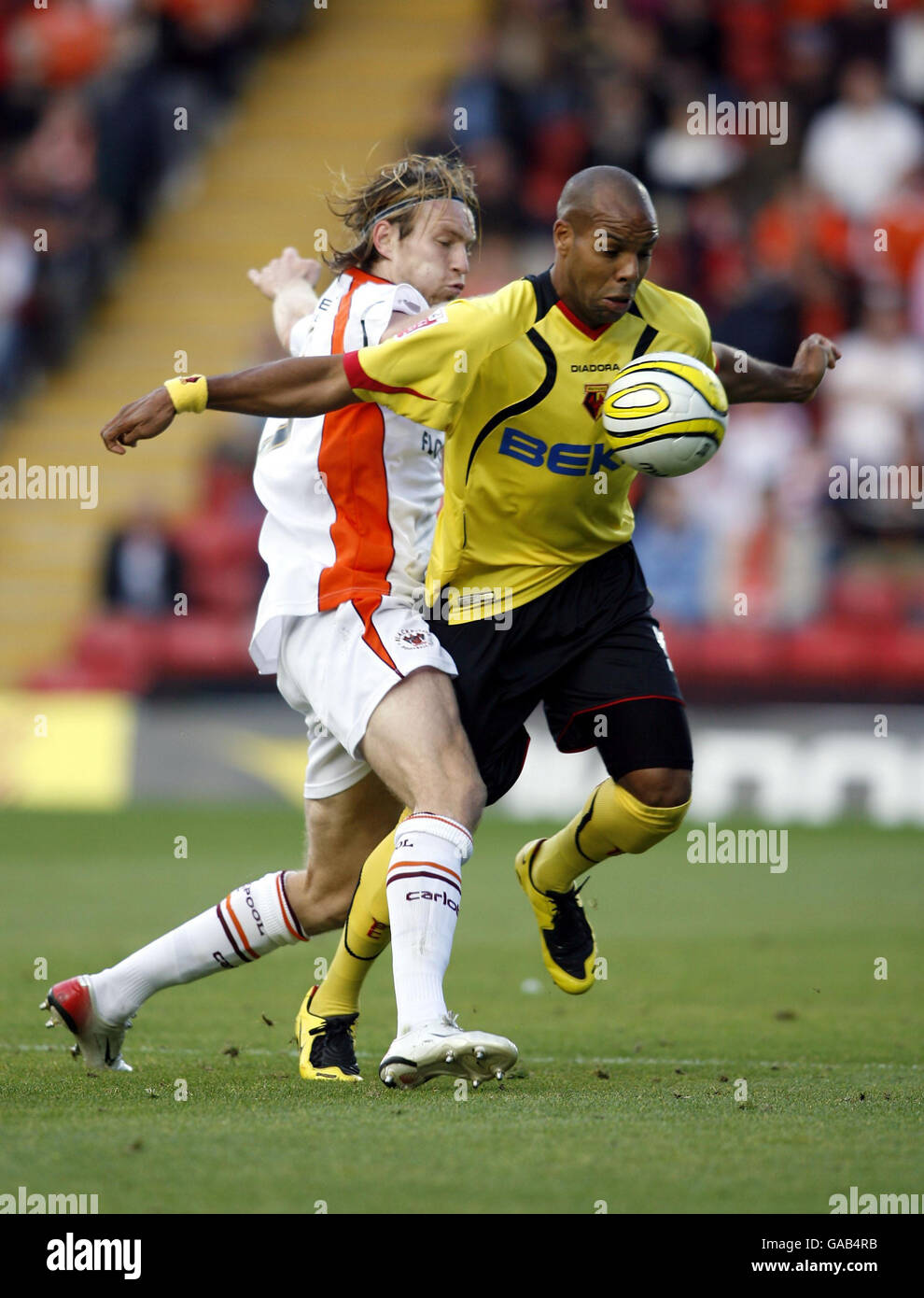 Watford's Marlon King (right) is challenged by Blackpool's Kaspars Gorkss during the Coca-Cola Football League Championship match at Vicarage Road, Watford. Stock Photo