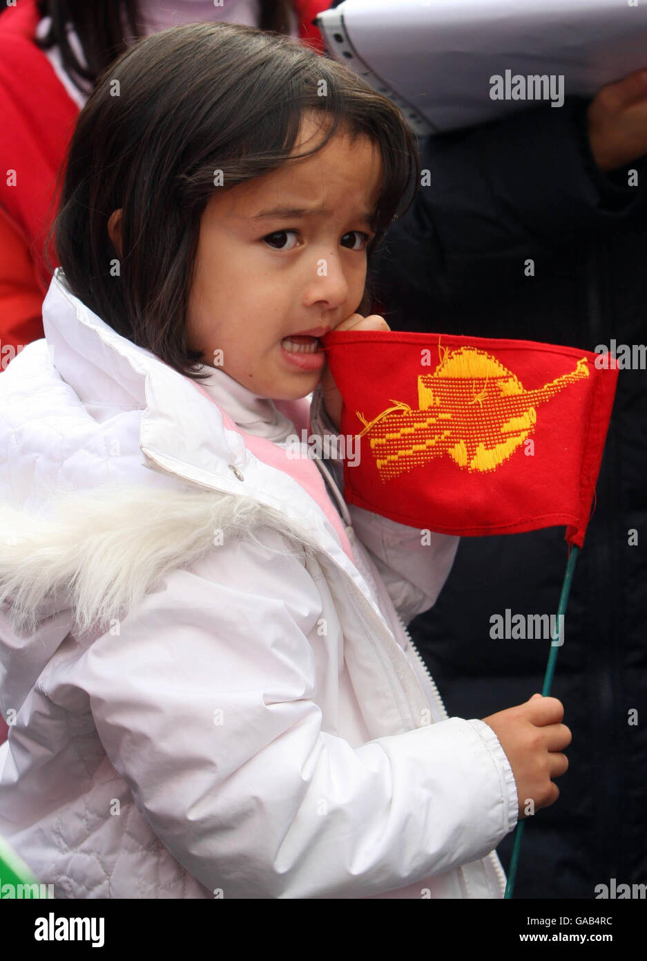 A young girl holds the fighting peacock flag of the Burma pro-democracy movement at a support rally in Dublin's O'Connell Street. Stock Photo