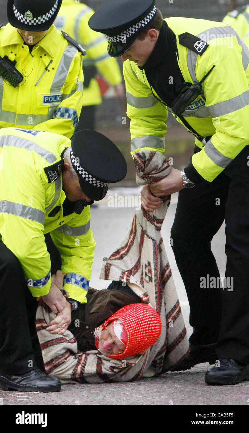 A protester is carried away by police at Faslane Naval Base during the last day of a year long anti nuclear protest at the site. Stock Photo